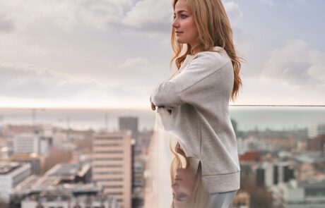 Sasha Digiulian looks out over a city skyline from a rooftop, part of Bentley's Bentayga social campaign.