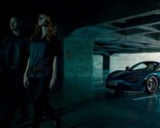 A man and woman walk away from the McLaren 720S Spyder in an underground car park.