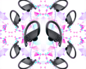 A symmetrical pattern with wireless earbuds. Eight pairs of black Beats headphones with over-ear hooks are arranged in a kaleidoscopic design. The background features an abstract geometric pattern with triangles in shades of pink, purple, and white, resembling the logo from Three network.