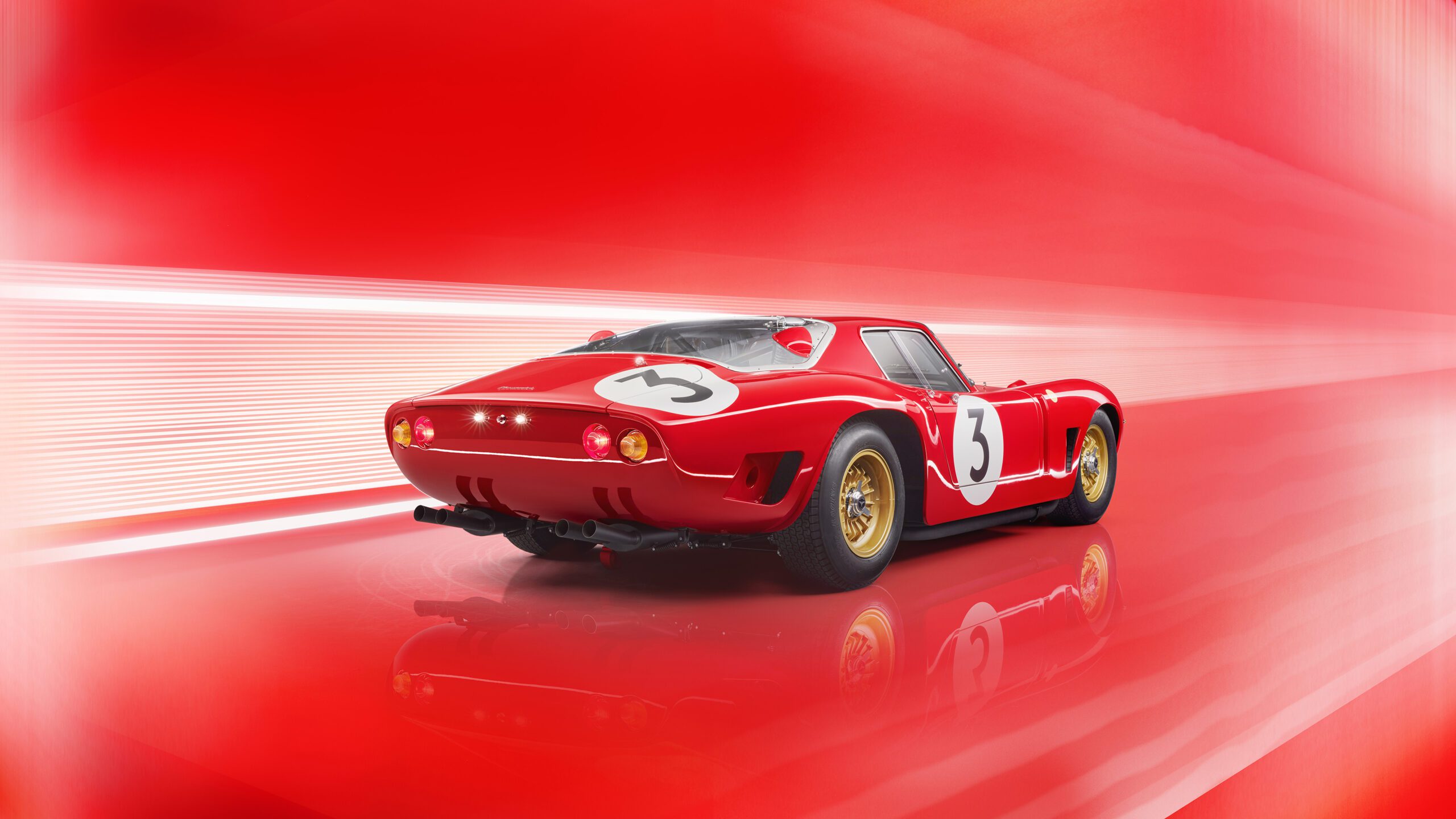 A retouched Bizzarrini 5300 GT Corsa Rossa, with the number 3 on its doors and rear, is displayed against a dynamic red and white gradient background. This vintage racing car features gold wheels and a sleek, aerodynamic design, reflecting light off its glossy surface.