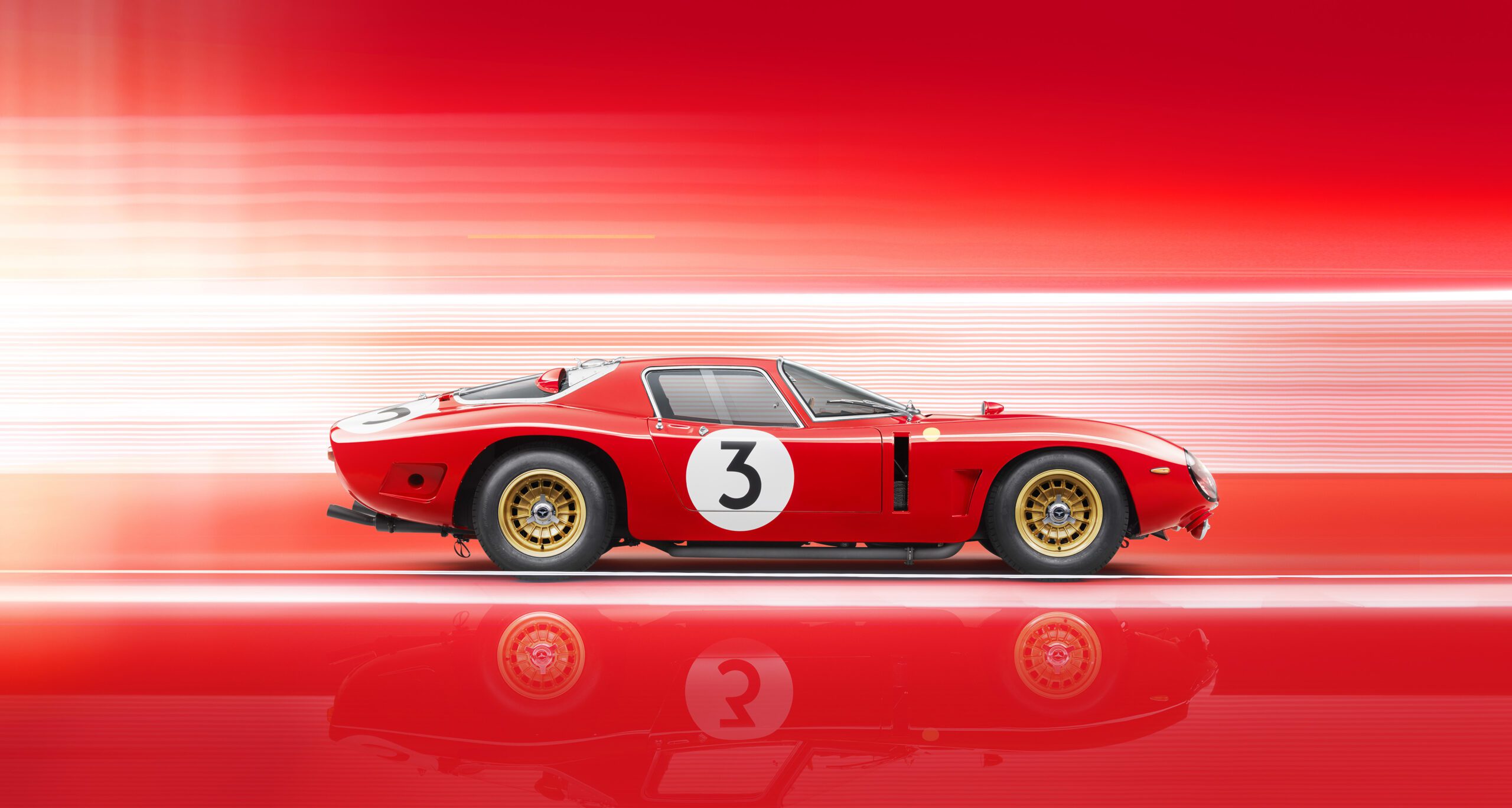 A sleek Bizzarrini 5300 GT Corsa Rossa with the number 3 on its side is set against a vibrant red and white gradient background. The car features gold-colored wheels and is captured in profile view with motion blur suggesting high speed. The scene has a dynamic, racing atmosphere, perfectly retouched.