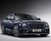 Front view of the Bentley Flying Spur, showing its chrome grille and polished alloy wheels.
