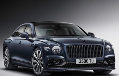 Front view of the Bentley Flying Spur, showing its chrome grille and polished alloy wheels.