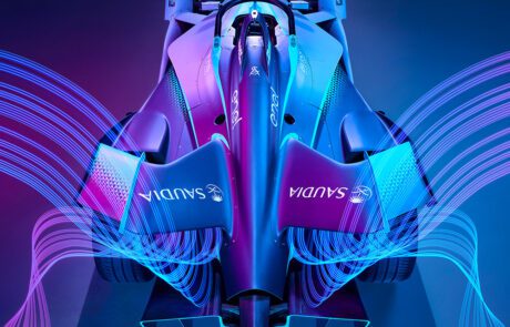 Front view of the Formula E Gen2 car with dramatic blue and pink light trails sweeping outward like wings.