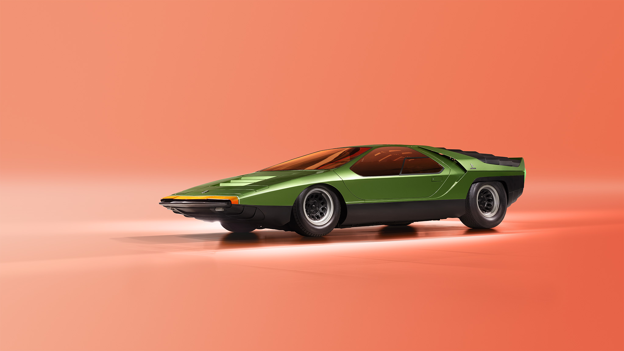 A sleek, green vintage concept car with an angular design and low profile is positioned against a minimalist, orange gradient background. Resembling the iconic Alfa Romeo 33, the car features black accents, large wheels, and a retro-futuristic aesthetic that looks straight out of an issue of Magneto Magazine.