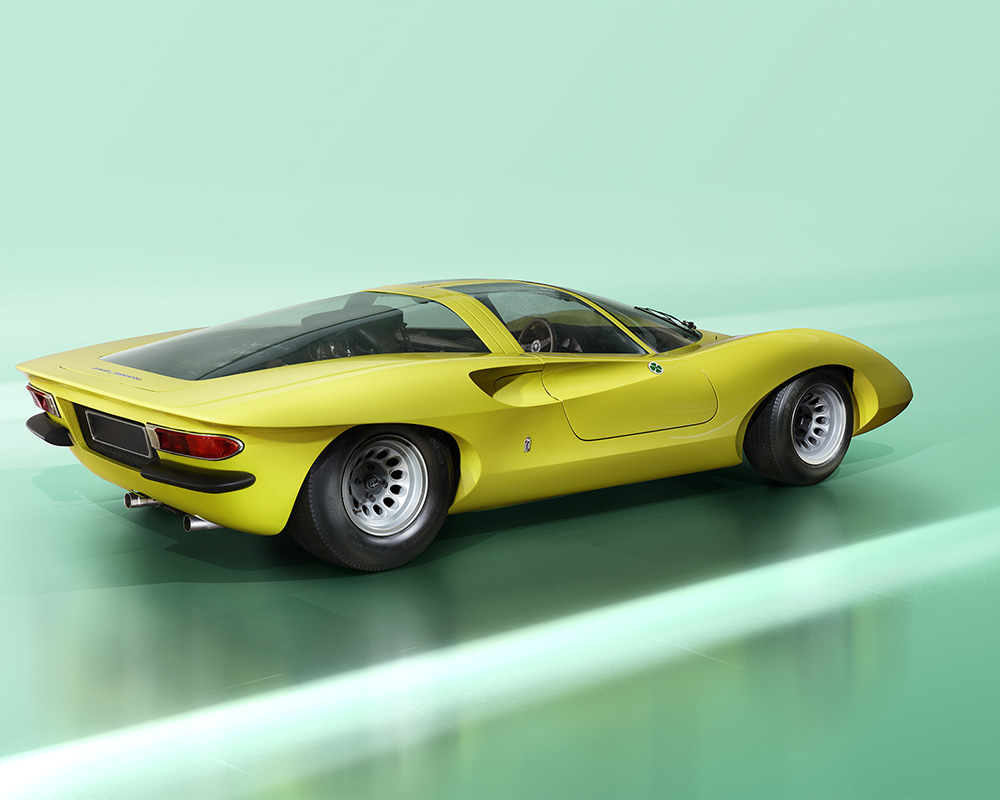 A sleek, vintage yellow sports car with a low, aerodynamic design. It features a curvy body reminiscent of the Alfa Romeo 33, large rear wheels, and a transparent roof, set against a smooth, light-green background. The car has round tail lights and a dual exhaust system.