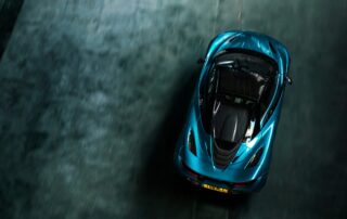 mclaren 720s above view Overhead view of the McLaren 720S Spyder with its roof down, parked on bare concrete.