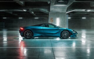 mclaren 720s side view wide-side-carpark.jpg Wide side view of the McLaren 720S Spyder, roof down, in an underground car park with concrete columns.