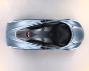 Overhead shot of a sleek, silver McLaren Speedtail with a streamlined design. The vehicle features a panoramic roof and a minimalist, aerodynamic body. Retouched to perfection by a skilled car retoucher, the smooth curves and futuristic look suggest a high-performance and modern luxury vehicle.