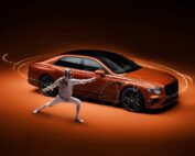 A fencer in full gear strikes a pose, with a sleek, orange luxury car in the background. The scene is dynamically lit, with motion trails accentuating the action, set against a warm, dark backdrop.