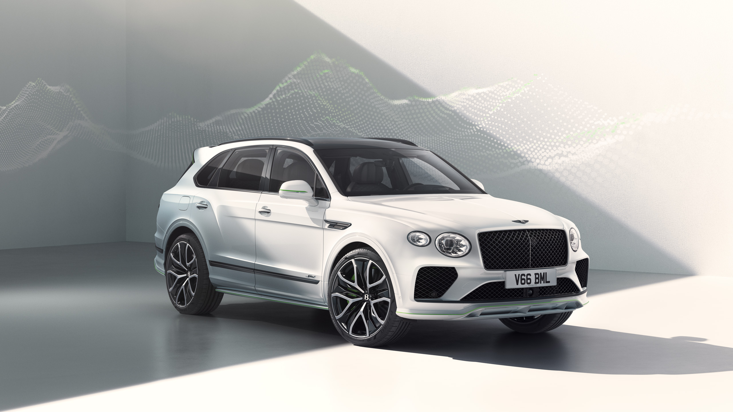 A white Bentley Bentayga luxury SUV is parked in a modern, minimalistic showroom with soft lighting and a wave-like graphic on the wall behind it.