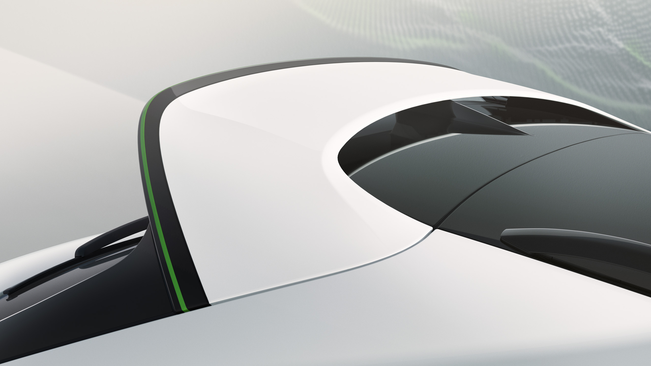 Close-up view of a sleek, white sports car roof with a black and green accent line and a sharply contoured rear windshield under soft lighting.