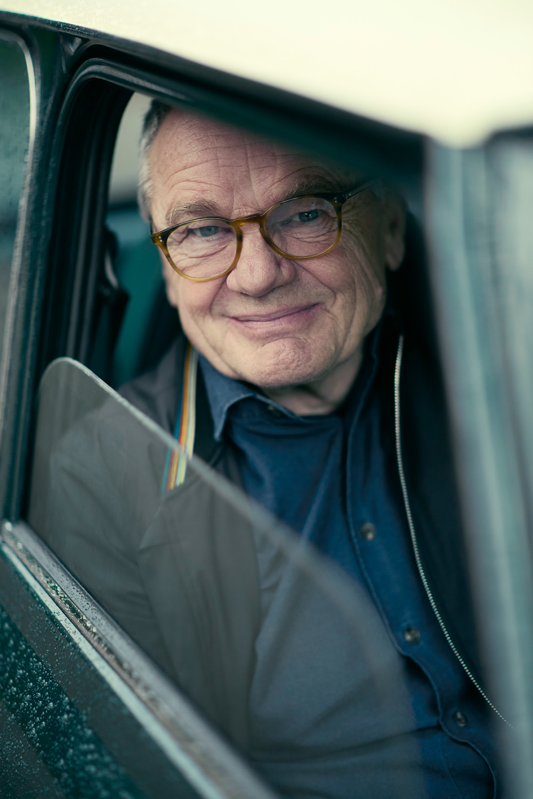 mike-cooper-obe-mini-cooper-window-portrait Mike Cooper OBE smiles through the open window of his new Mini Cooper Grand Prix on a rainy day.