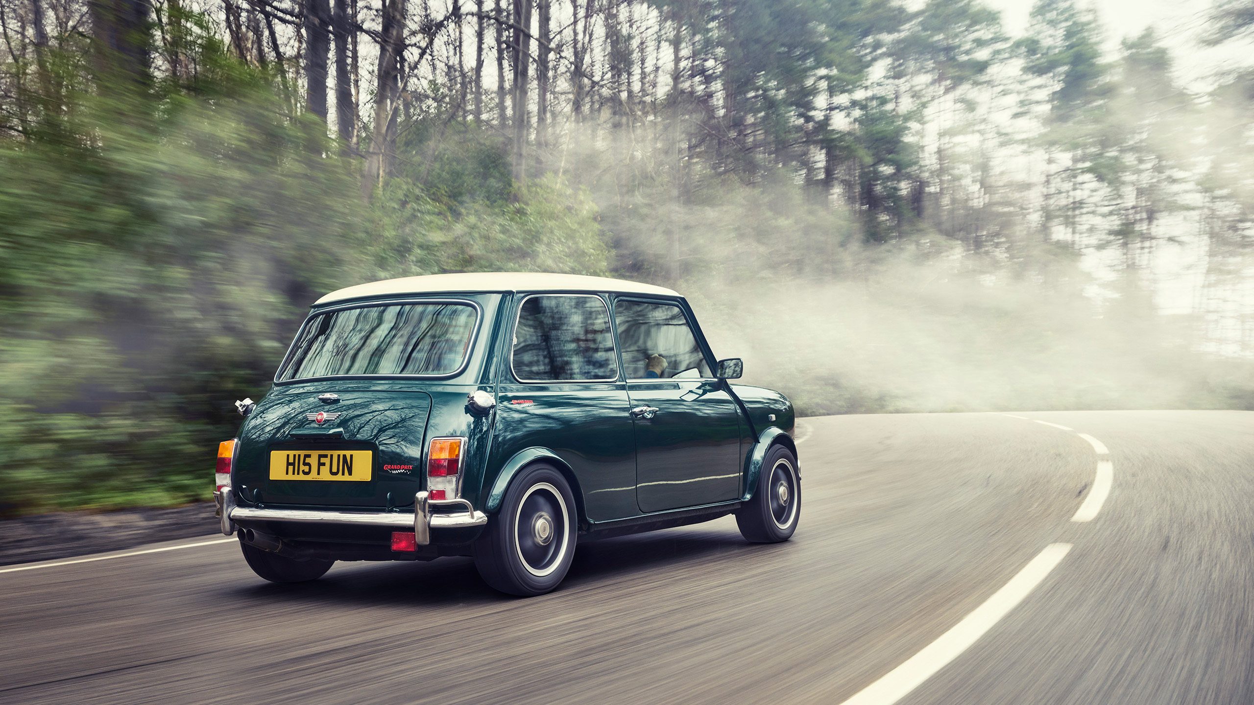 mini-cooper-grand-prix-cooper-cars-rear-three-quarter-fog Rear three-quarter view of the Mini Cooper Grand Prix cornering on a misty road with fog.