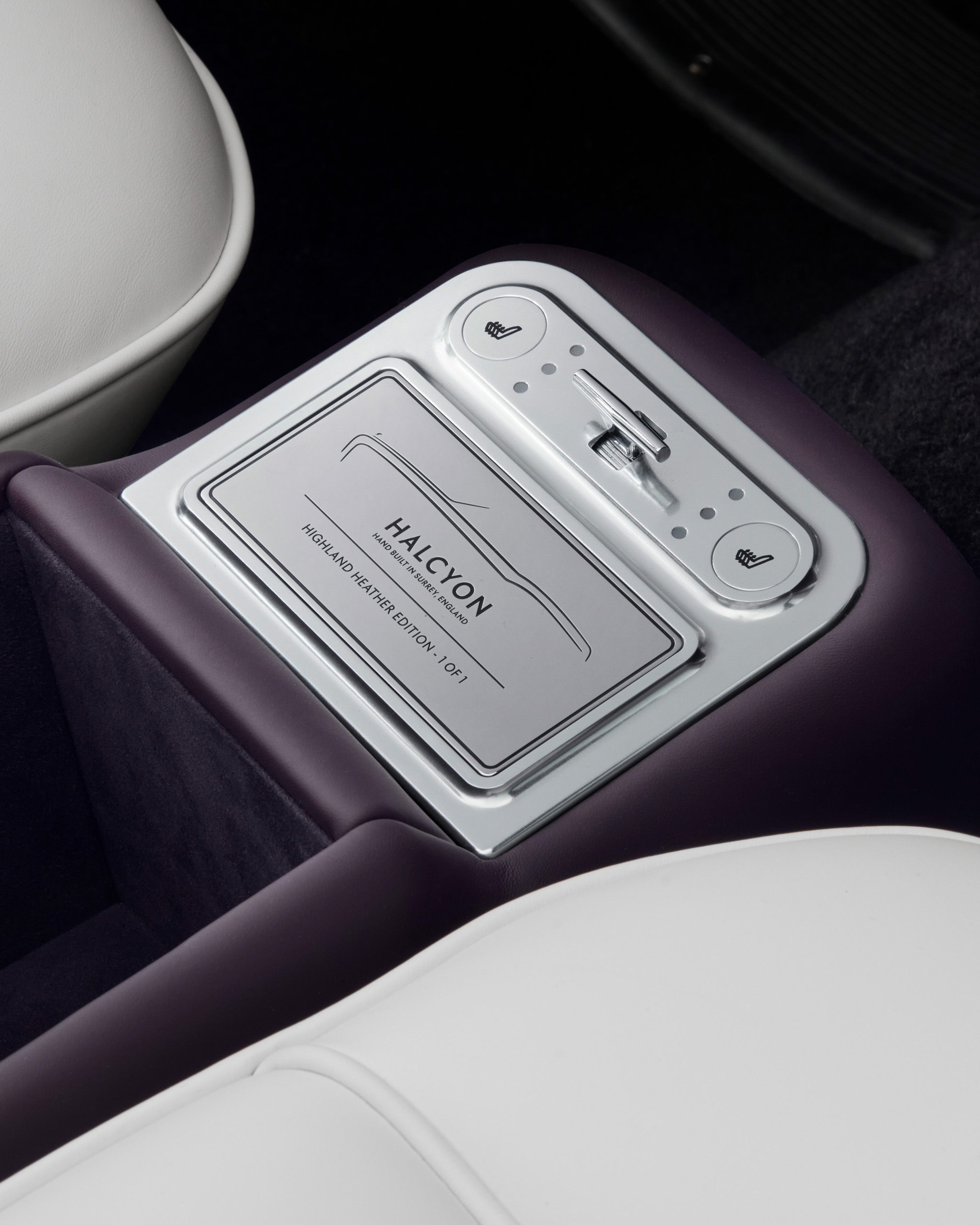 halcyon-electric-rolls-royce-corniche-edition-plaque.jpg Close-up of the Halcyon dash plaque, marked "Highland Heather Edition — 1 of 1" and "Hand Built in Surrey, England", set into the centre console beside the heated seat controls.