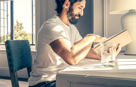 A guest reads quietly in a sunlit room at The Ranch wellness retreat, New York State