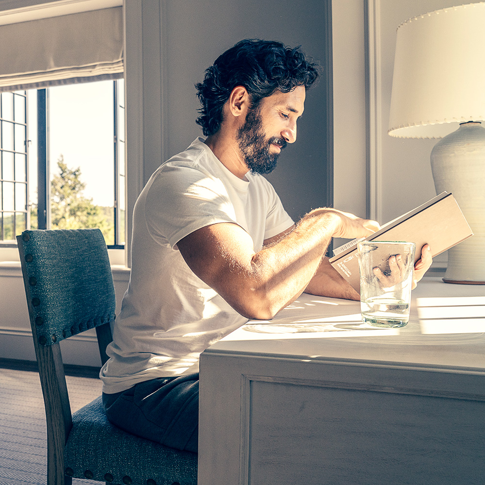 A guest reads quietly in a sunlit room at The Ranch wellness retreat, New York State