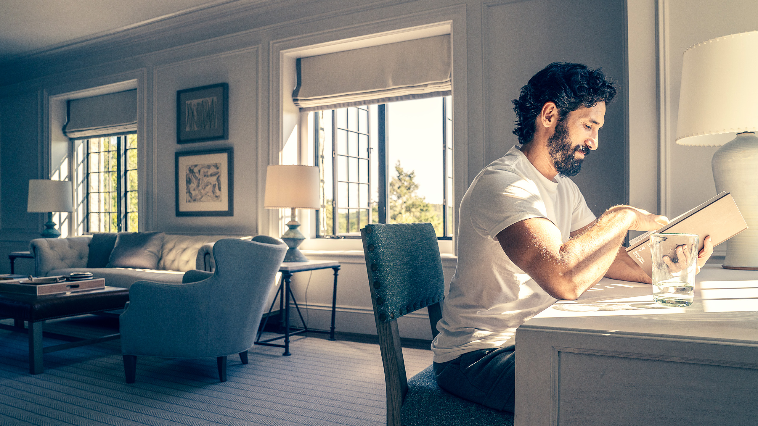 the-ranch-hudson-valley-man-reading A guest reads quietly in a sunlit room at The Ranch wellness retreat, New York State