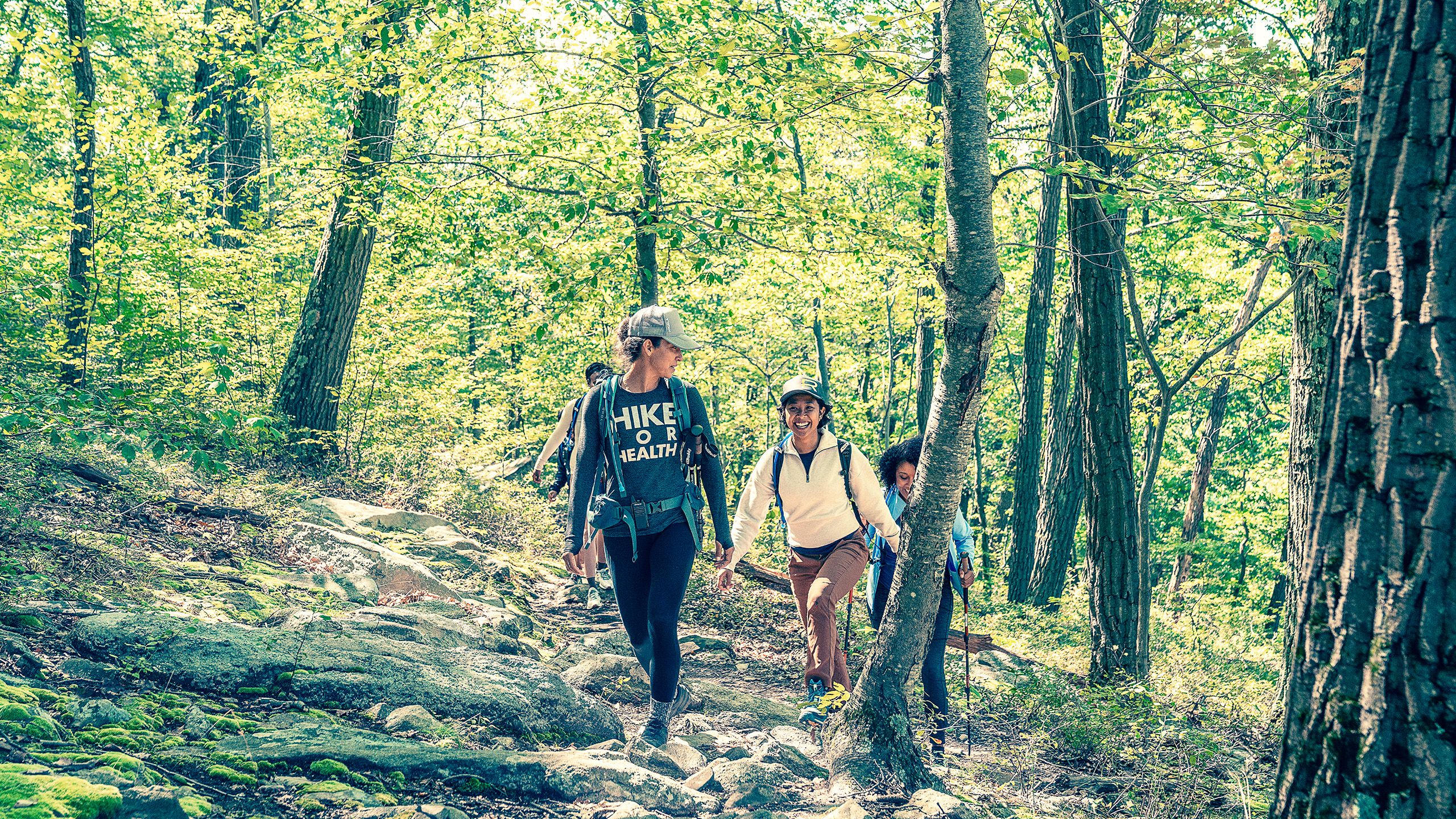the-ranch-hudson-valley-forest-hike Guests hike a wooded trail at The Ranch wellness retreat, New York State.