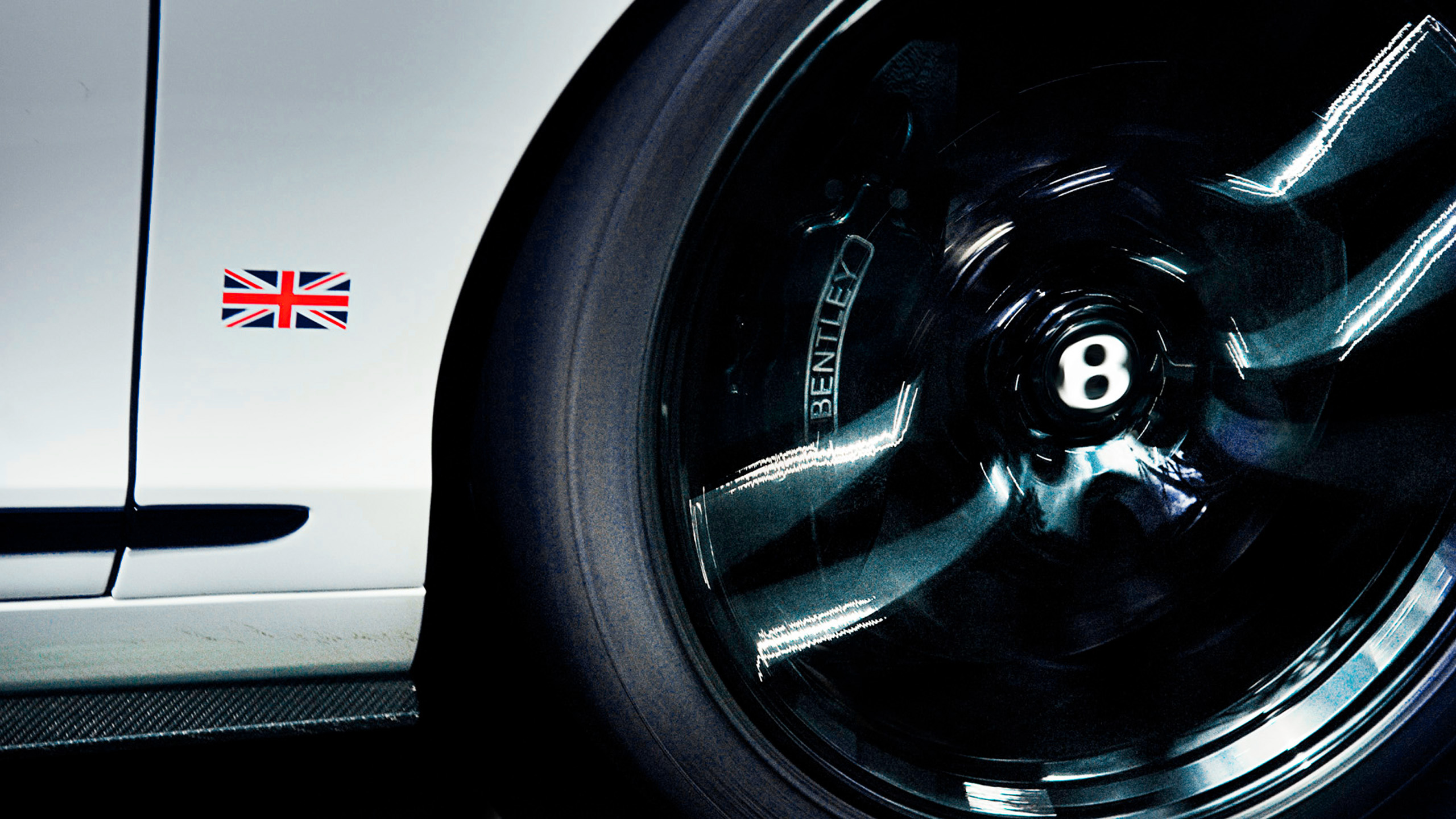 bentley-continental-gt3-race-car-wheel-detail Close-up of a Bentley Continental GT3 race car's wheel and Union Jack decal, showing the polished alloy and Bentley wheel centre.
