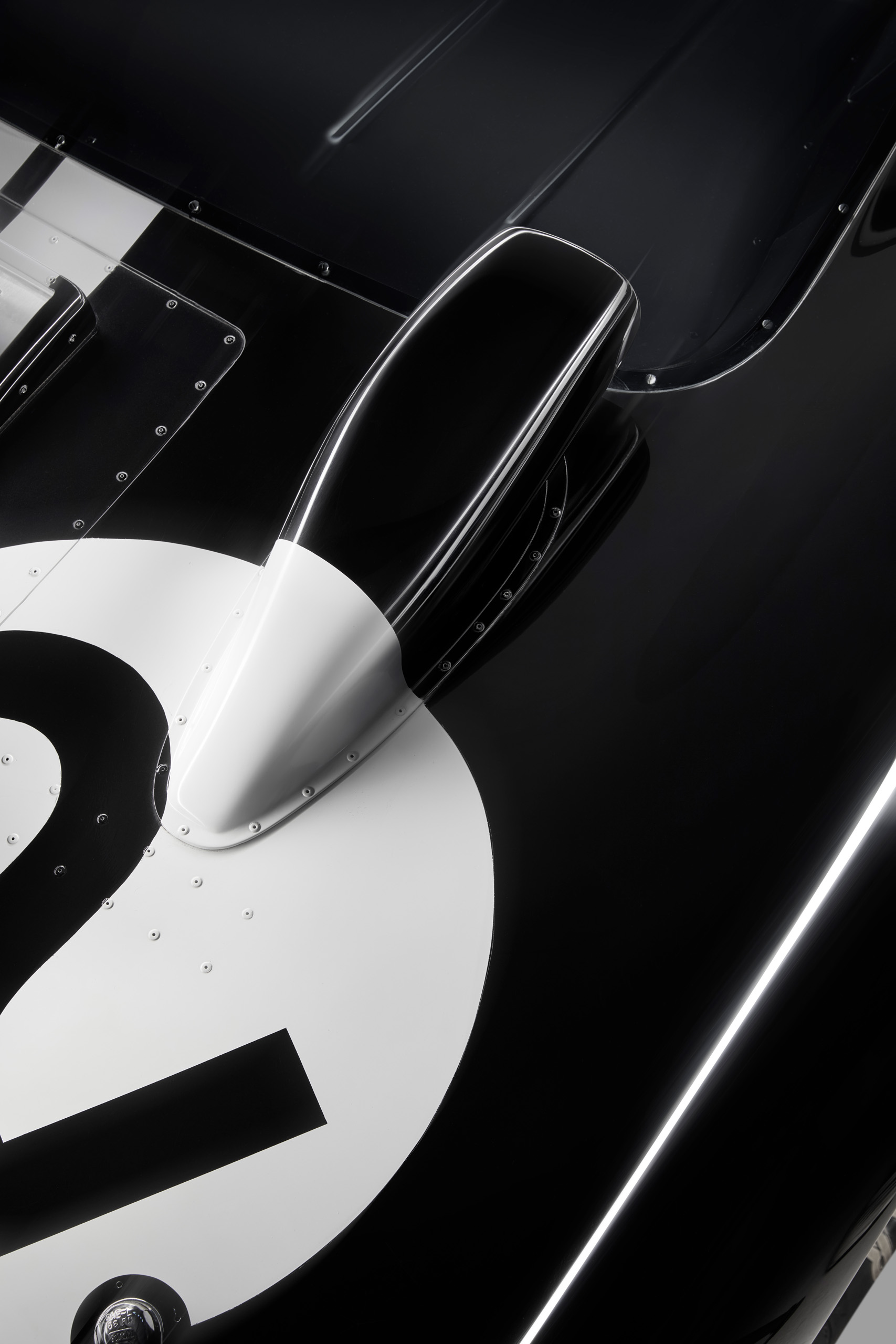 ford-gt40-1966-le-mans-black-car-2-intake-detail_16x9 Overhead detail of the number 2 Ford GT40's rear air intake, from the 1966 Le Mans-winning trio, shot for Magneto.