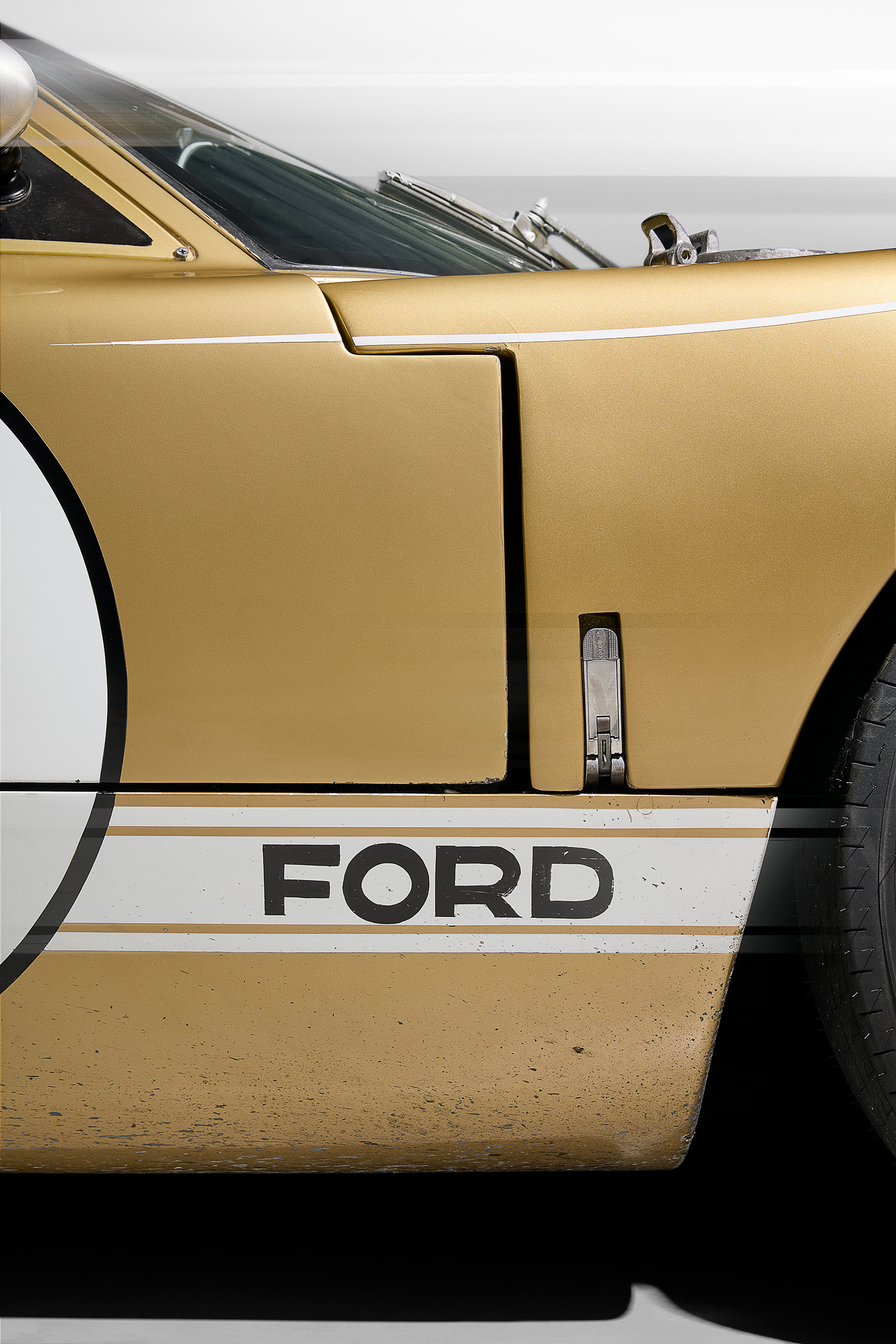 ford-gt40-1966-le-mans-gold-car-5-ford-logo-detail Close-up of the "Ford" lettering and door detail on the gold number 5 Ford GT40 from the 1966 Le Mans-winning trio.