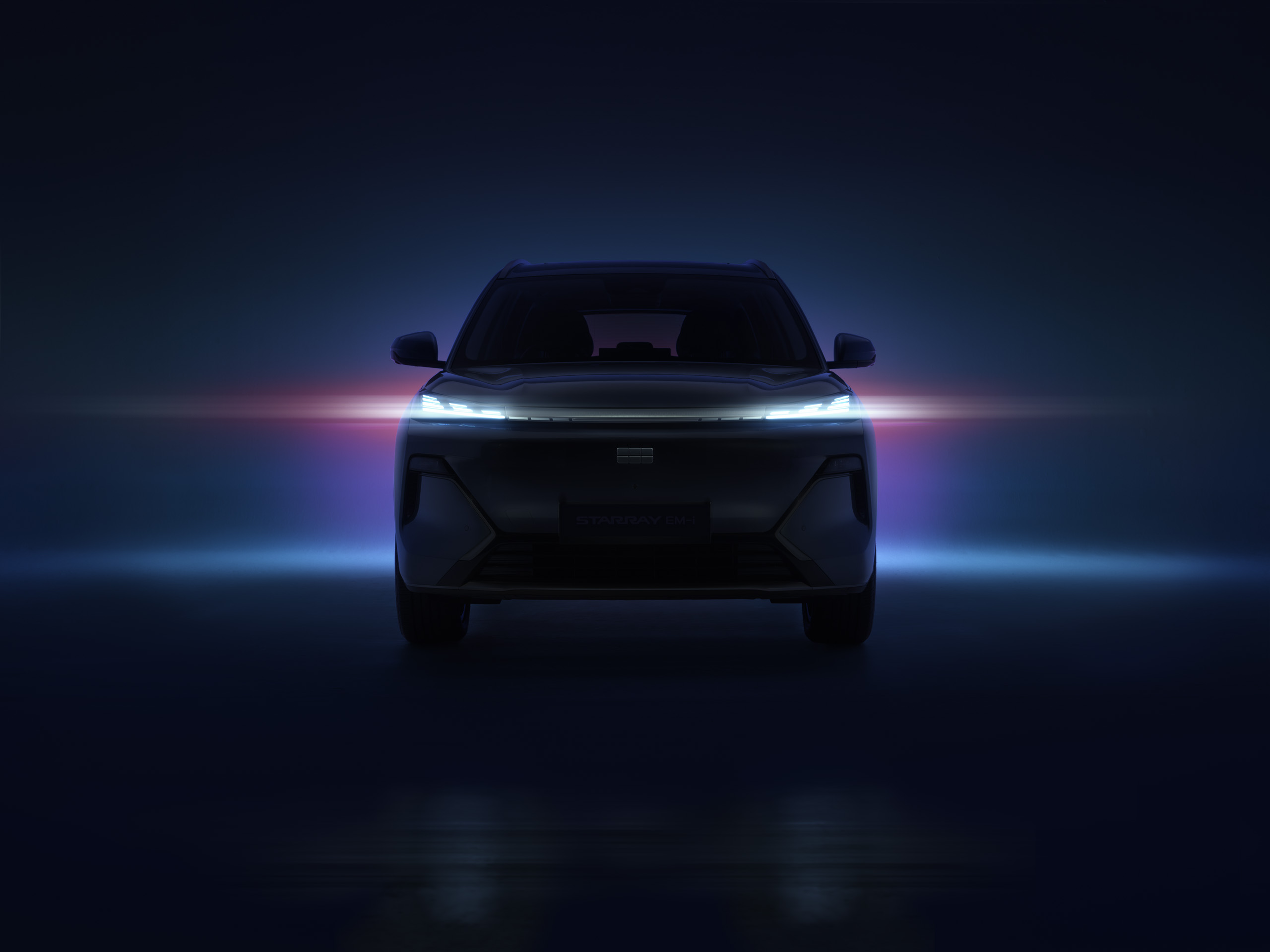 geely-starray-emi-teaser-front-on Pre-launch teaser image of the Geely Starray EM-i, shown front-on in darkness with its LED daytime running lights lit.
