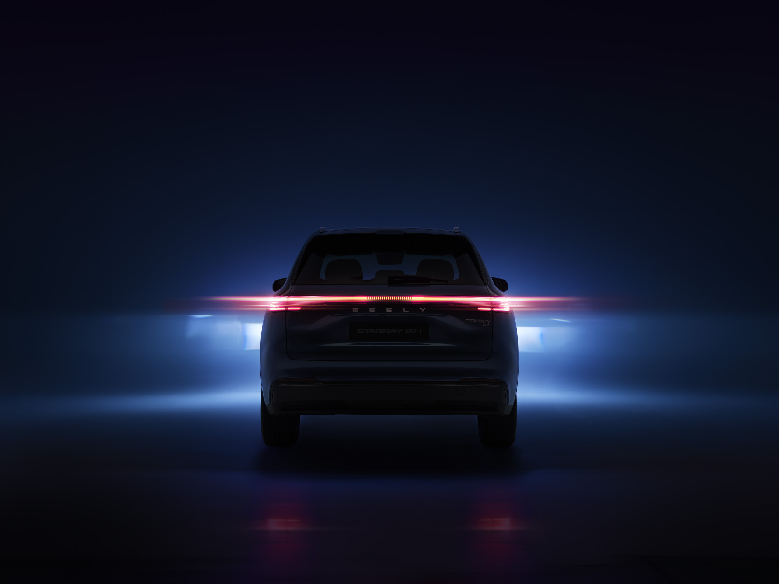 geely-starray-emi-teaser-rear Pre-launch teaser image of the Geely Starray EM-i, rear view, showing its illuminated full-width tail light bar and Geely badge.