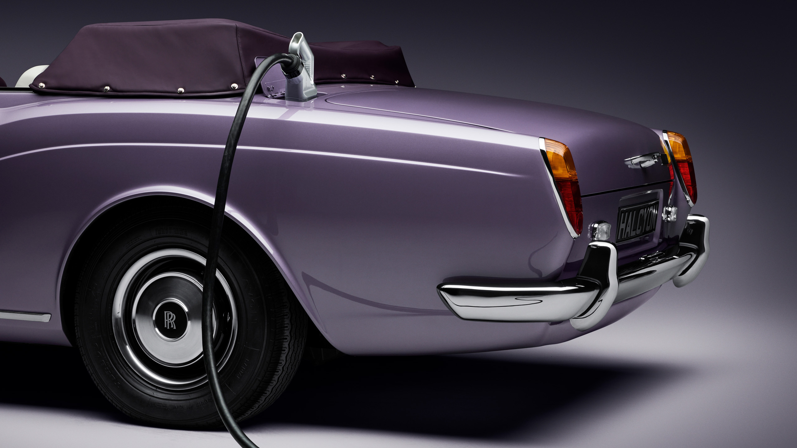 halcyon-electric-rolls-royce-corniche-charging-port-detail Close-up of the Halcyon electric Rolls-Royce Corniche's charging port and cable, set into the rear wing beside the taillight.