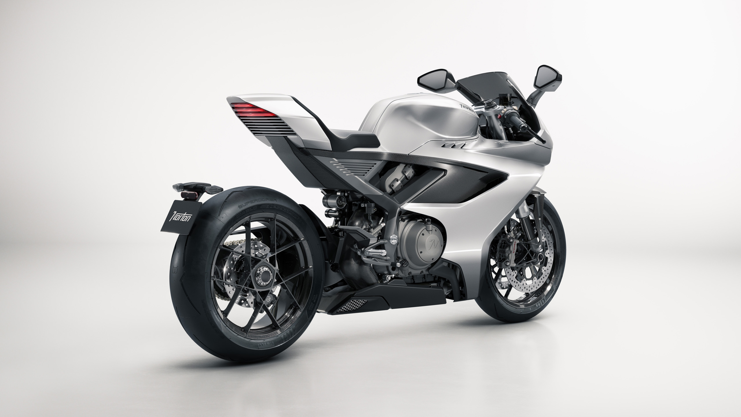norton-manxr-cgi-rear-three-quarter-16×9 CGI render of the Norton ManxR motorcycle, rear three-quarter view with illuminated tail light.