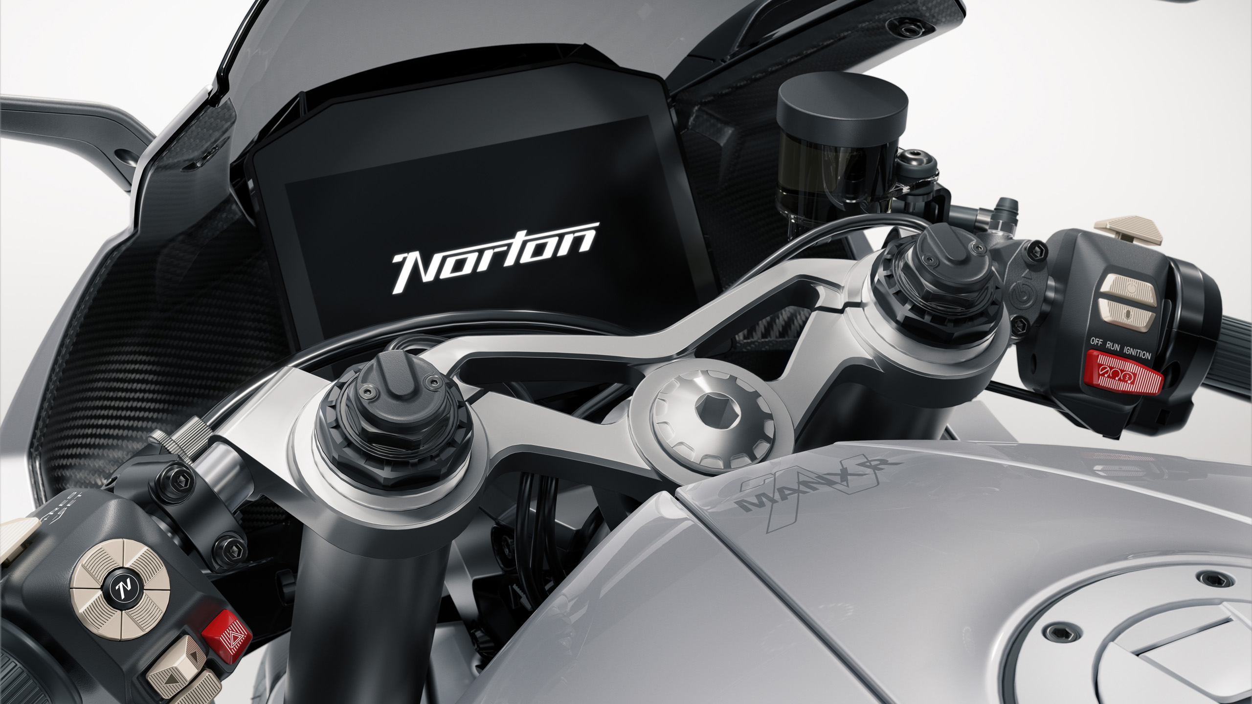 norton-manxr-cgi-yoke-dash-detail-16×9 Close-up CGI detail of the Norton ManxR's top yoke and digital dash display showing the Norton logo.